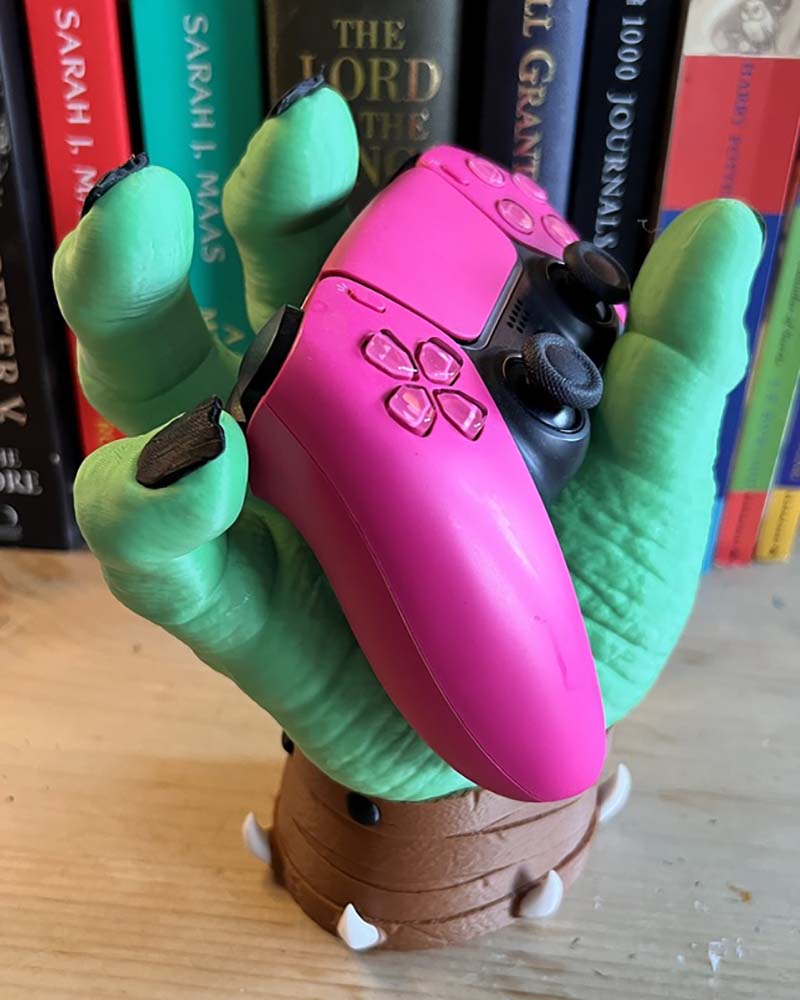 Green orc hand controller holder gripping a pink PS5 controller —  3D printed gamer gift by Loonar 3D
