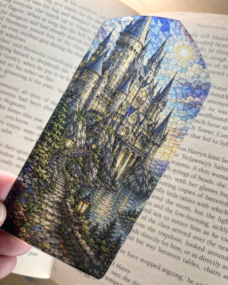 Rivendell stained glass style 3D printed bookmark featuring an Elven fantasy city surrounded by mountains, woodland, flowers and water.