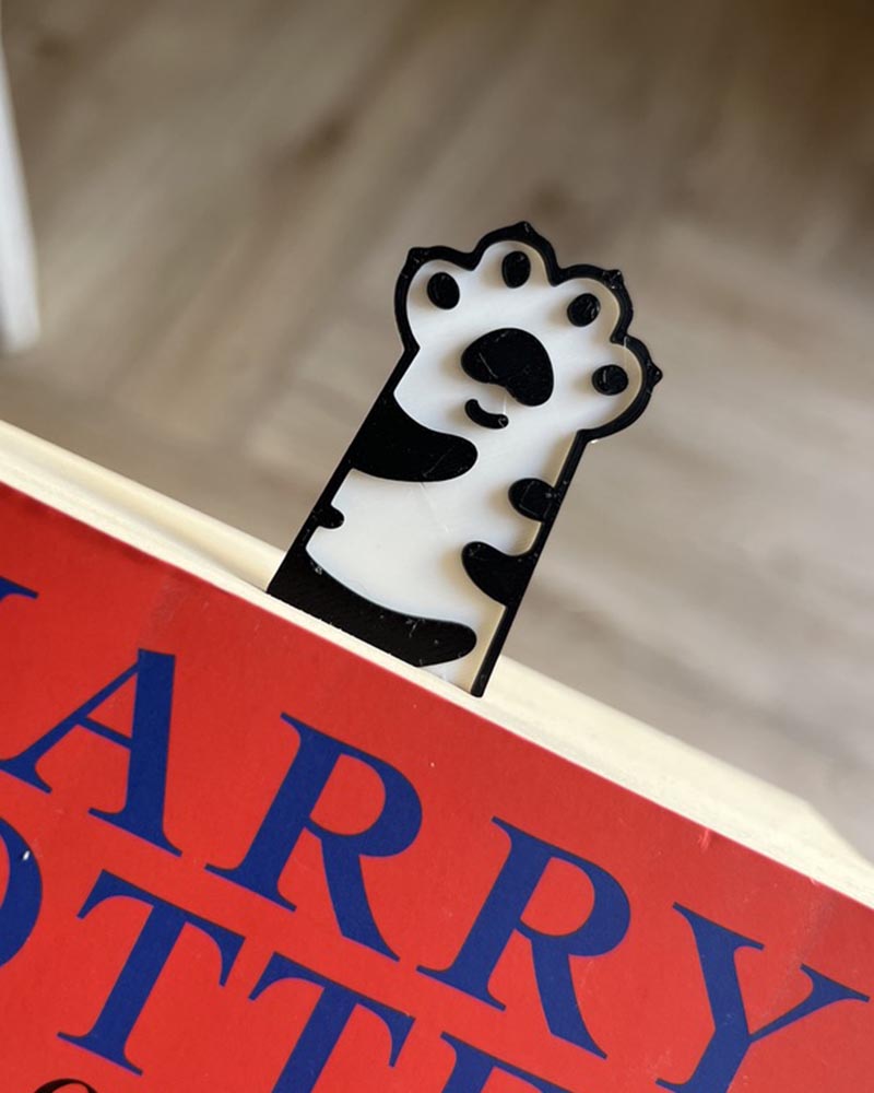 cute cat paw bookmarks reaching out of book