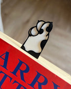 cat paw bookmark clipped onto book page cute reading accessory 