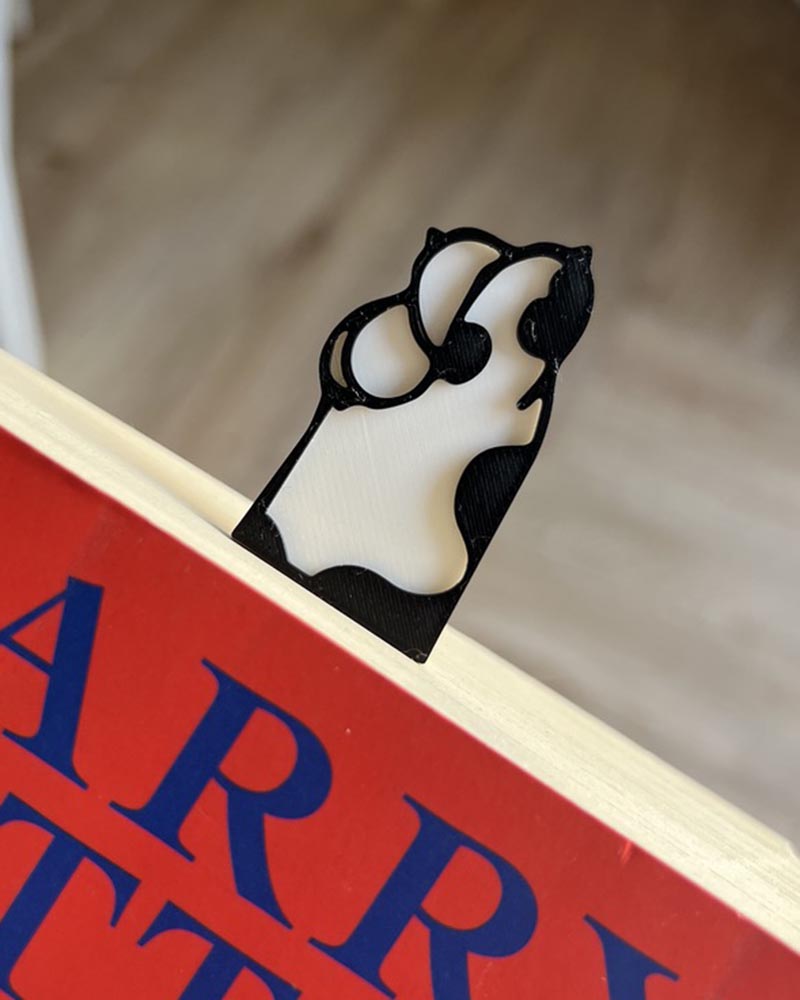 cat paw bookmark clipped onto book page cute reading accessory 