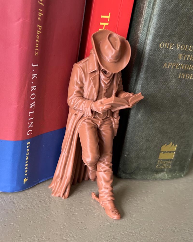 Cowboy Leaning Book Figurine