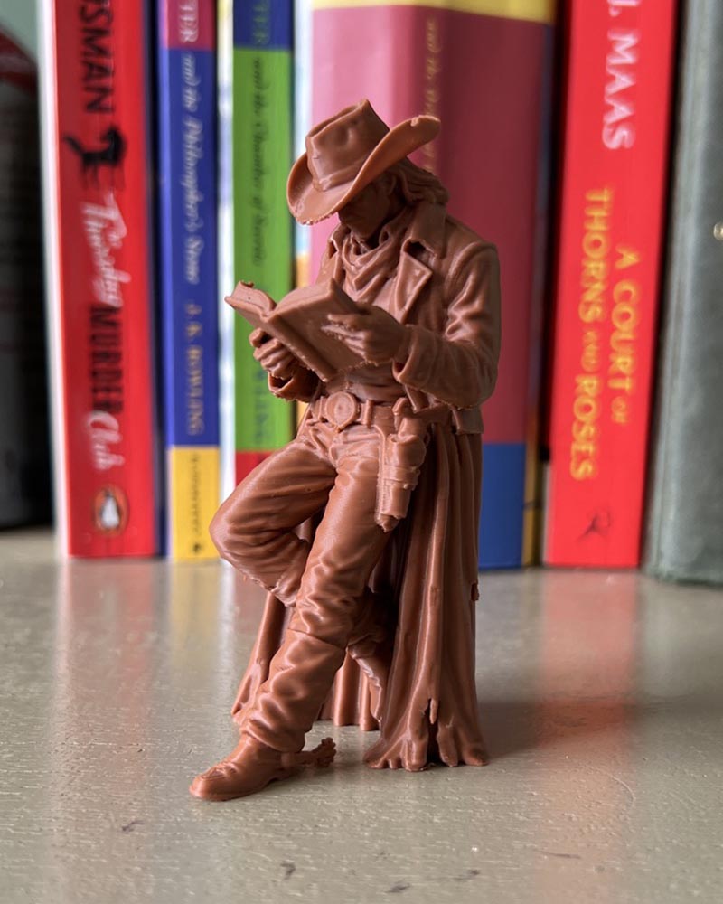 Cowboy Leaning Book Figurine