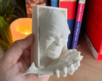 Hand holding Lord of the rings Gollum book nook for size reference against bookshelf