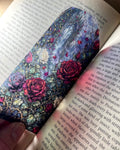 Gothic rose stained glass window bookmark featuring red and ivory roses, thorny vines and a mysterious gothic castle archway.
