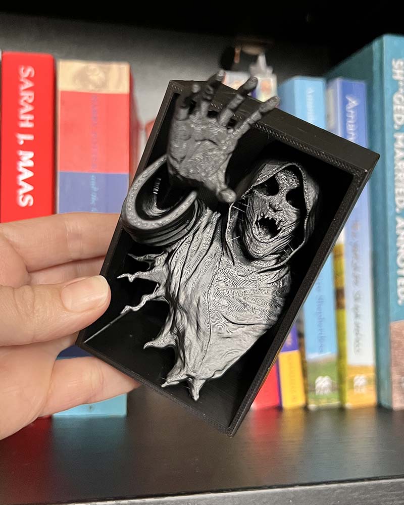 Dementor figure between books with flowing robes