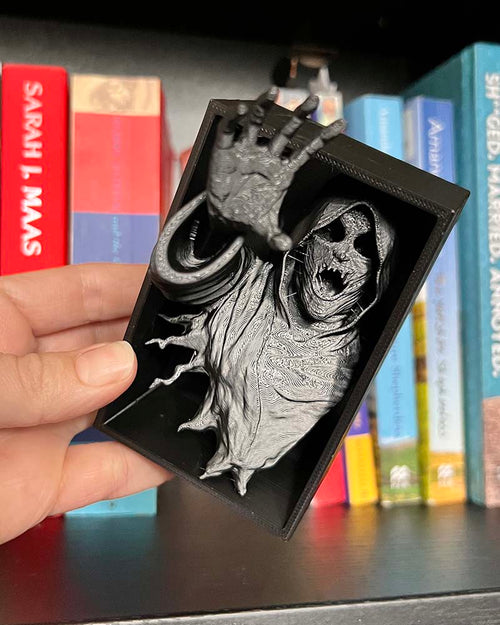 Dementor figure between books with flowing robes