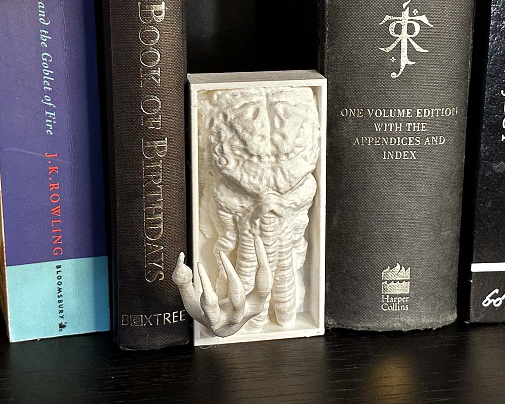 Mind Flayer figure between books for tabletop gamers