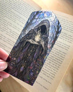 Suriel inspired stained glass style bookmark featuring a mysterious hooded faceless fantasy figure holding a steaming cup of tea beneath a moonlit sky.