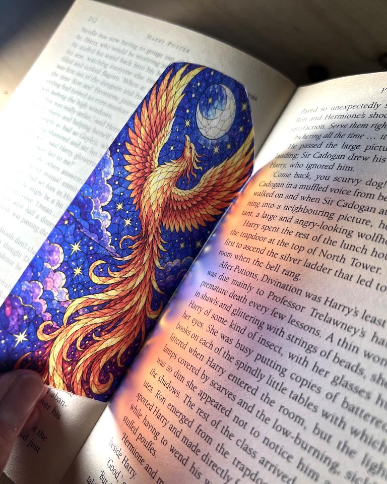 blue and gold phoenix stained glass style 3D printed bookmark featuring a mythical firebird beneath the moon and stars.