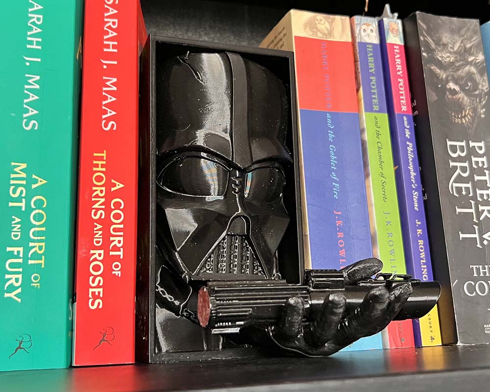 Darth Vader book nook with lightsaber in hand 3D printed Star Wars shelf insert featuring Darth Vader Sith Lord bookshelf décor with lightsaber detail Dark Side Darth Vader book nook gift for Star Wars fans Cinematic book nook insert Darth Vader holding lightsaber
